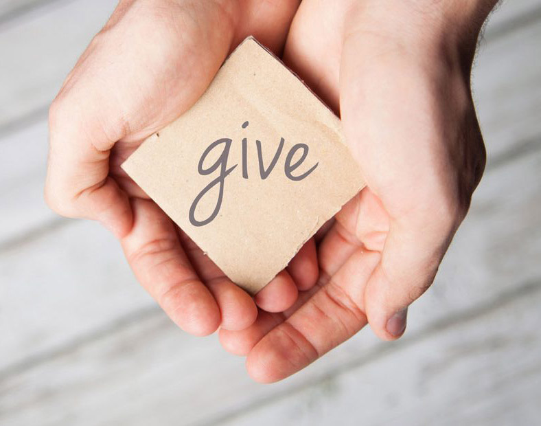 Hands holding a gift of giving
